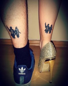 two people with tattoos on their legs and one has a high heel shoe in front of them