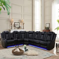 a living room filled with black leather furniture