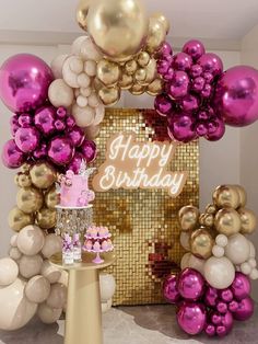 a pink and gold birthday party with balloons