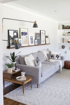 a living room filled with furniture and pictures on the wall