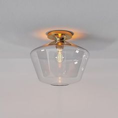 a glass light fixture hanging from the ceiling