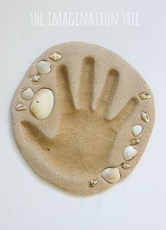 a clay hand and seashells on a white background with the text, the imaginative tree