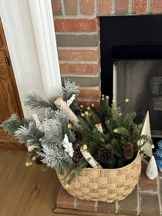 a basket filled with pine cones sitting on top of a fireplace