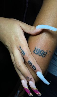 two hands with white and pink nails holding each other