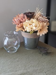 there is a vase with flowers in it on the table