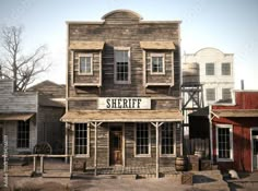 an old western town with wooden buildings and signs on the front door, in sepia tone