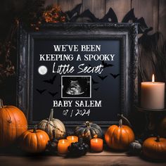 an image of a halloween scene with pumpkins, candles and a framed photo that says we've been keeping a spooky little secret