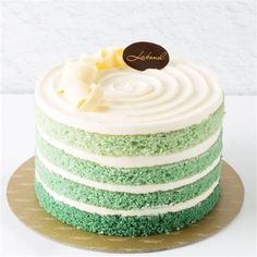 a green and white cake sitting on top of a plate