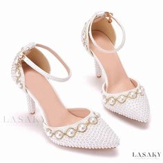 a pair of white shoes with pearls on them