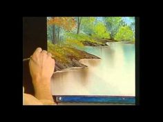 someone is painting a landscape with water and trees