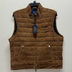 This Polo Ralph Lauren Suede Vest Is A Size Xl. This Is A Brown Suede Vest Featuring A Quilted Design. This Is A Full Zip Vest With A Double Zipper. On The Outside Of The Vest, It Has 2 Zip Pockets And An Open Chest Pocket. On The Inside Of The Vest, There Is A Zip Pocket, And Open Pockets. Interior Lining Features A Green Plaid Design. The Exterior Material Is 100% Goat Suede, Lining Is 100% Cotton, And The Filling Is 100% Polyester. **This Vest Is New With Tags. There Is An Imperfection In The Luxury Sleeveless Outerwear For Fall, Luxury Brown Casual Vest, Luxury Brown Vest With Pockets, Fitted Rugged Brown Vest, Rugged Brown Winter Vest, Mens Brown Quilted Vest, Suede Vest, Classic Clothing, Lauren Brown