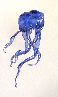 a blue jellyfish floating on top of a white wall