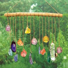 a wind chime with many different colored glass beads hanging from it's strings