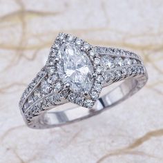 a diamond ring with two rows of diamonds on top of it, sitting on a marble surface