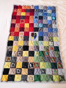 a quilt made with squares and pictures is laying on top of a white bed sheet