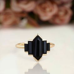 a black stone ring sitting on top of a table