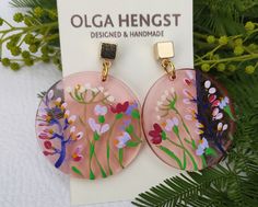 Unusual pink transparent earrings with delicate flowers.  Flowers are painted by me. Very nice effect. photography does not convey all the tenderness and beauty of the decoration.  Hand-made earrings,  hand-painted floral design in acrylics.  Hypoallergenic stainless steel cube posts in 18K real Gold Plated. circle diameter 32 mm, 1,2 inc. cube size 5 x 5 mm Artistic Pink Flower Jewelry, Pink Flower-shaped Earrings With Pressed Flowers, Pink Pressed Flower Drop Earrings, Pink Drop Earrings With Pressed Flowers, Pink Flower Earrings With Pressed Flowers, Unique Pink Flower Earrings As Gift, Unique Pink Flower Earrings For Gifts, Bohemian Pink Hand Painted Earrings, Pink Dangle Earrings With Pressed Flowers