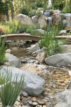 there is a small waterfall in the middle of this garden