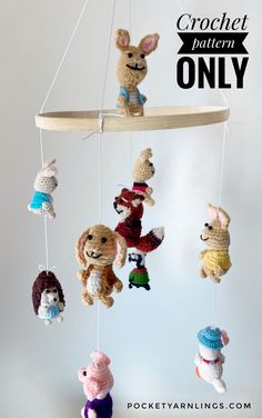 crocheted stuffed animals are hanging from a wooden mobile with the words crochet pattern only on it