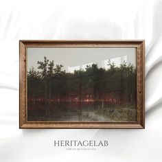 a painting hanging on the wall next to a white sheet that says heritage lab with an image of a forest