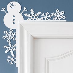 a white door with snowflakes on it and a blue wall in the background