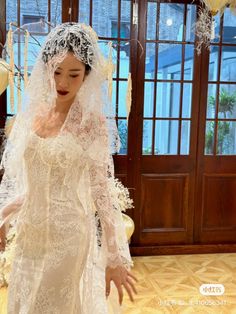 a woman in a white wedding dress and veil