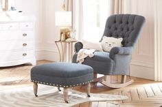 a rocking chair and foot stool in a child's room with white walls, wooden floors and flooring