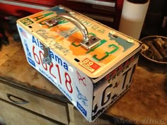 an old license plate box sitting on top of a counter