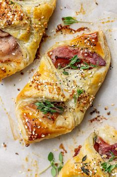 three pastries with meat, cheese and herbs