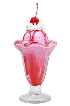 a pink ice cream sundae sitting on top of a glass cup with a cherry on top