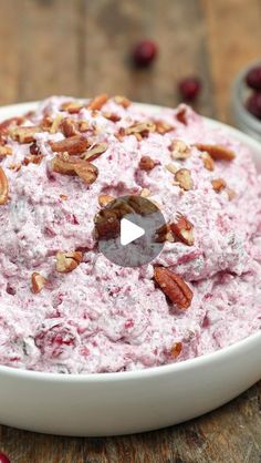 a bowl filled with cranberry salad on top of a wooden table