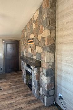 a stone fireplace in the corner of a room