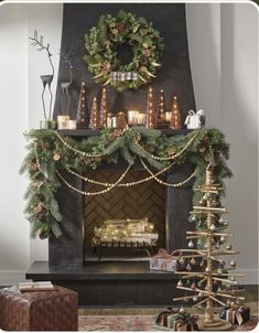 a fireplace decorated for christmas with candles and wreaths