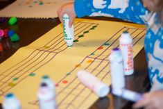 a child is playing with crayons on the table