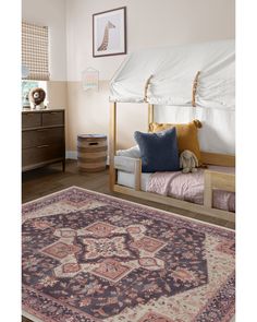 a bedroom with two beds and a rug on the floor