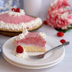 a piece of cake on a plate with a fork next to it and flowers in the background