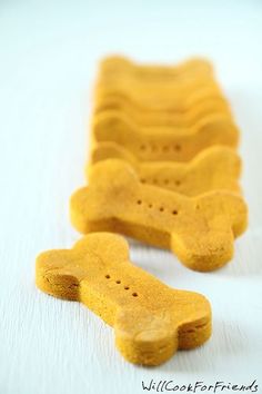 two yellow dog bone shaped treats sitting on top of each other