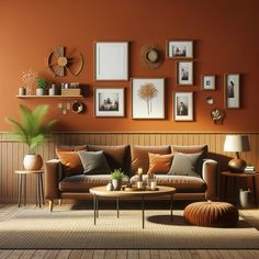 a living room with orange walls and pictures on the wall above the brown couches