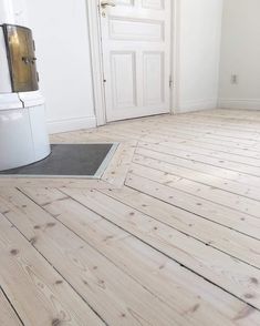 an empty room with white walls and wood flooring on the bottom part of it