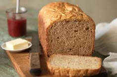 a loaf of bread sitting on top of a wooden cutting board