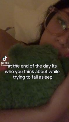 a woman laying in bed holding a teddy bear with a caption above it that reads, at the end of the day its who you think about while trying to fall asleep