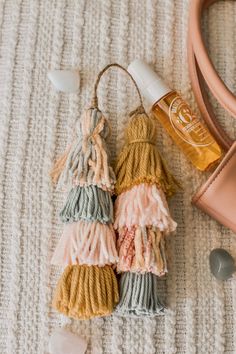 the contents of a handbag laid out on top of a white blanket next to a pink purse