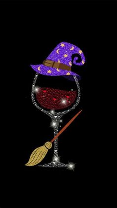 a wine glass with a witch's hat and broom