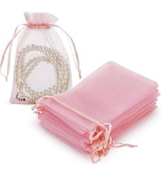 a pink organ bag with pearls on it next to a stack of folded napkins