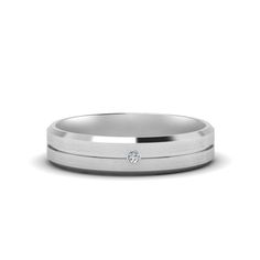 a wedding band with a diamond in the center