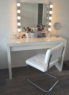 a white chair sitting in front of a vanity