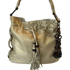 Authentic Juicy Couture Royal Couture Shoulder Bag Vintage Collectable Beautiful Bag ! Very Rare Htf Authentic Juicy Couture Leather Bag Y2k Made From Super Soft Leather And Is To Die For! The Color Is A Soft Light Gold Tone And The Leather Is Unbelievably Soft. Hardware Is Gold Tone (Brass) And Is Accented With Wood Beads And Leather Tassels. Large Wood Oval And Brass Rings Attach The Shoulder Strap. This Is A Used Bag But Shows Little Signs Of Wear. In Great Condition. Please See Photos For Imperfections. G&P In 1996 They Changed The Name To Juicy Couture. All Juicy Couture Items Are Manufactured With The Company Signature Logo: Two Highland Terriers Holding A Shield Bearing Three Hear Rare Juicy Couture Bag, Luxury Gold Hobo Bag, Designer Gold Hobo Shoulder Bag, Designer Gold Hobo Bag For Evenings, Designer Gold Hobo Bag For Evening, Designer Bucket Hobo Bag For Evening, Designer Evening Bucket Hobo Bag, Designer Hobo Bag With Silver-tone Hardware, Royal Couture