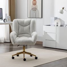 a white office chair sitting on top of a rug in front of a desk with a computer monitor