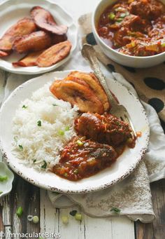 two plates filled with meat and rice on top of a table