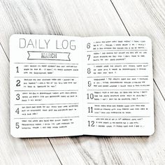 the daily log is open on top of a wooden table